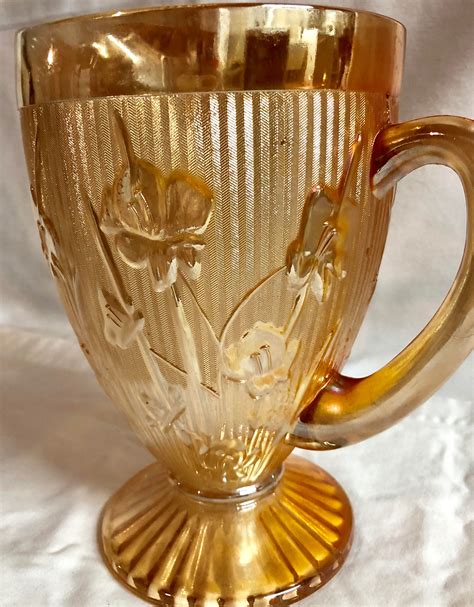  35. . Vintage glass pitcher with flowers